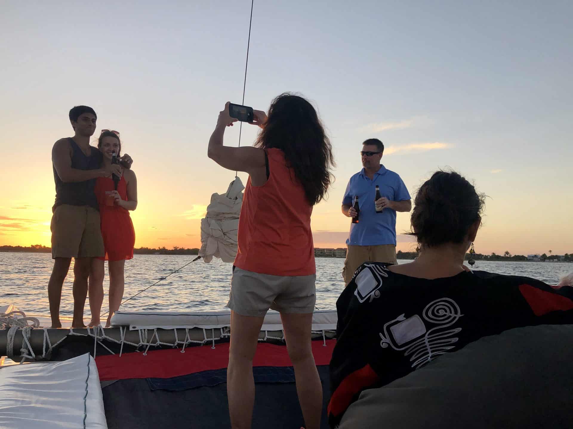 A couple pose during sunset sailing cruise in Ambergris Caye
